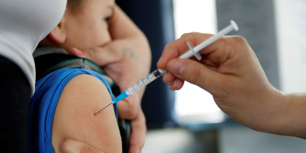 A child is vaccinated against the influenza H1N1 in a mobile vaccination center in Montevideo's downtown after health authorities announced an outbreak of the disease in Uruguay, May 27, 2016. REUTERS/Andres Stapff