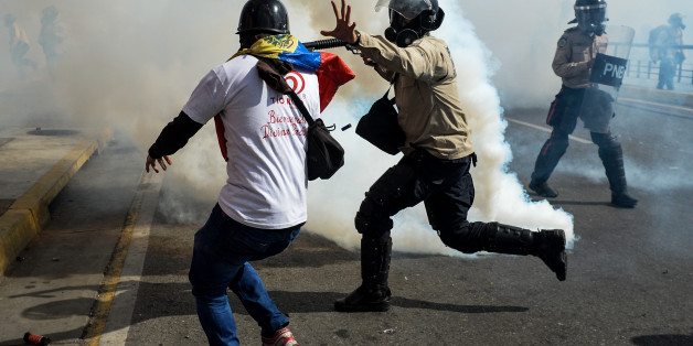 A riot policeman struggles with a demonstrator during a protest against the government of President Nicolas Maduro in Caracas on May 20, 2017.
Venezuelan protesters and supporters of embattled President Nicolas Maduro take to the streets Saturday as a deadly political crisis plays out in a divided country on the verge of paralysis. / AFP PHOTO / FEDERICO PARRA (Photo credit should read FEDERICO PARRA/AFP/Getty Images)