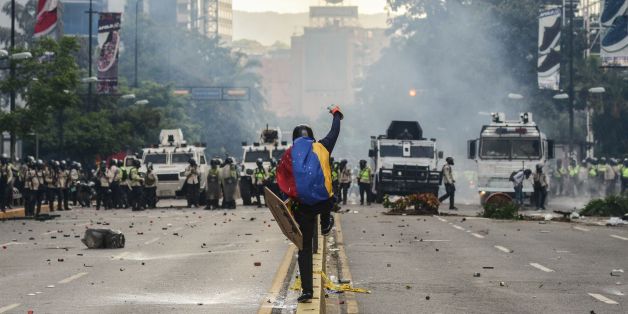 Riot police clash with demonstrators during a protest against the government of President Nicolas Maduro in Caracas on May 20, 2017. Venezuelan protesters and supporters of embattled President Nicolas Maduro take to the streets Saturday as a deadly political crisis plays out in a divided country on the verge of paralysis. / AFP PHOTO / FEDERICO PARRA (Photo credit should read FEDERICO PARRA/AFP/Getty Images)