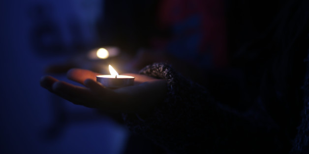 A youth sits next to a cross made of flowers at a candle light vigil in solidarity with Egyptian Christians after attacks targeting two churches, in Gaza City, Monday, April 10, 2017. A double suicide bombing by the Islamic State group against two Christian churches in Egypt killed at least 45 people.
(Photo by Majdi Fathi/NurPhoto via Getty Images)