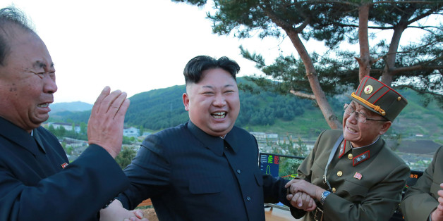 TOPSHOT - This picture taken on May 14, 2017 and released from North Korea's official Korean Central News Agency (KCNA) on May 15 shows North Korean leader Kim Jong-Un (2nd L) reacting during a test launch of a ground-to-ground medium long-range strategic ballistic rocket Hwasong-12 at an undisclosed location. / AFP PHOTO / KCNA VIA KNS / STR / South Korea OUT / REPUBLIC OF KOREA OUT ---EDITORS NOTE--- RESTRICTED TO EDITORIAL USE - MANDATORY CREDIT 'AFP PHOTO/KCNA VIA KNS' - NO MARKETING NO AD