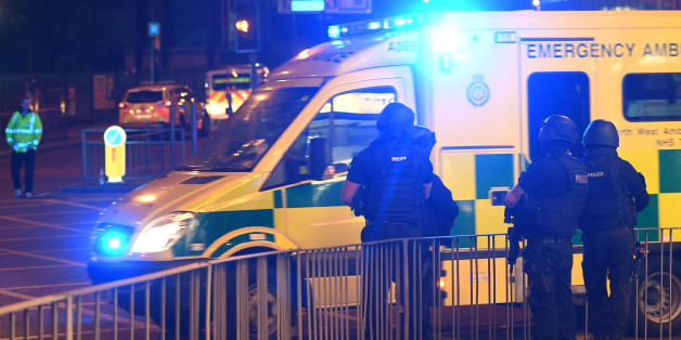Armed police stand guard at the scene of a suspected terrorist attack during a pop concert by US star Ariana Grande in Manchester, northwest England on May 23, 2017. / AFP PHOTO / Paul ELLIS (Photo credit should read PAUL ELLIS/AFP/Getty Images)