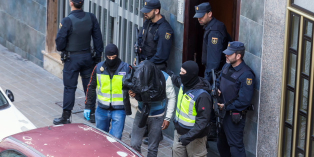A man (C) suspected of belonging to Islamic State is led by Spanish National Police officers after being detained in Las Palmas, Spain, February 14, 2017. REUTERS/Borja Suarez