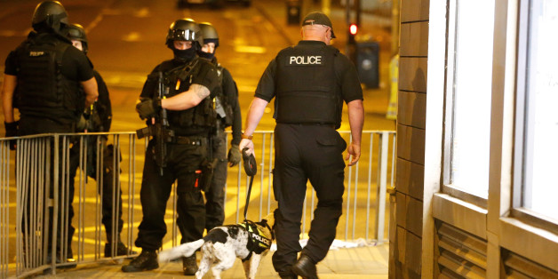 Armed police officers stand near the Manchester Arena, where U.S. singer Ariana Grande had been performing, in Manchester, in northern England, Britain May 23, 2017. REUTERS/Andrew Yates