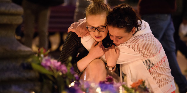 MANCHESTER, ENGLAND - MAY 23: A woman is consoled as she looks at the floral tributes following an evening vigil outside the Town Hall on May 23, 2017 in Manchester, England. An explosion occurred at Manchester Arena as concert goers were leaving the venue after Ariana Grande had performed. Greater Manchester Police are treating the explosion as a terrorist attack and have confirmed 22 fatalities and 59 injured. (Photo by Leon Neal/Getty Images)