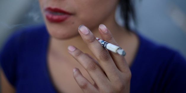 A woman smokes a Pall Mall cigarette in Ciudad Juarez, Mexico May 11, 2017. Picture taken May 11, 2017. REUTERS/Jose Luis Gonzalez