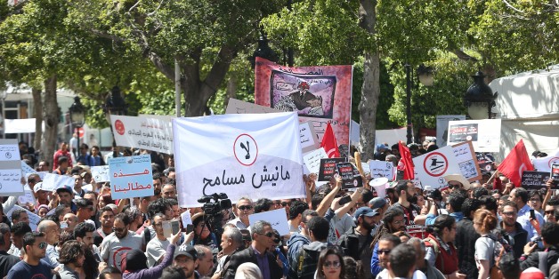 TUNIS, TUNISIA - APRIL 29: People hold banners during a protest against government's bill on Economic and Financial Reconciliation in Tunis, Tunisa on April 29, 2017. (Photo by Yassine Gaidi/Anadolu Agency/Getty Images)