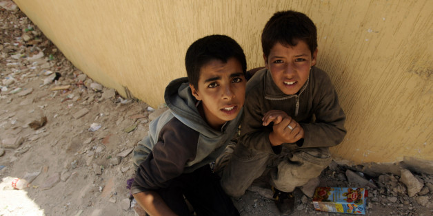 Two homeless children hide from the police near the port in Tangier, July 11, 2007. Approximately two thousand homeless minors live on the streets of Tangier according to the Al Jaima association, an association that works with street kids, and most of them are victims of the drugs and the prostitution. REUTERS/Rafael Marchante (MOROCCO)
