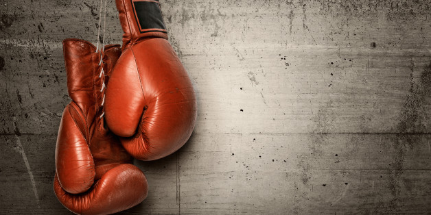 Boxing gloves hanging on concrete wall -including clipping path