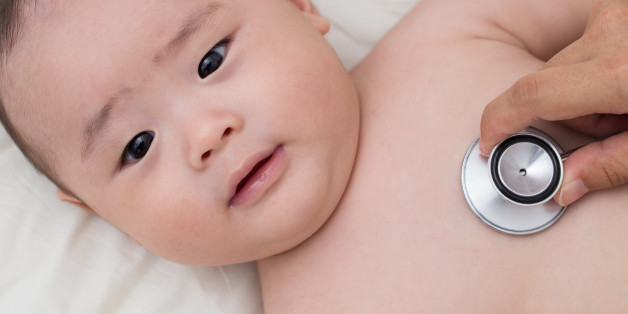 Doctor using a stethoscope to listen to baby's chest
