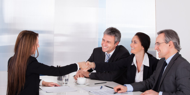 Businessmen Looking At Business Women Shaking Hand