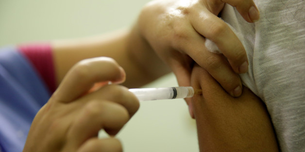 A woman is vaccinated during a campaign of vaccination against yellow fever in Rio de Janeiro, Brazil, March 25, 2017. REUTERS/Ricardo Moraes