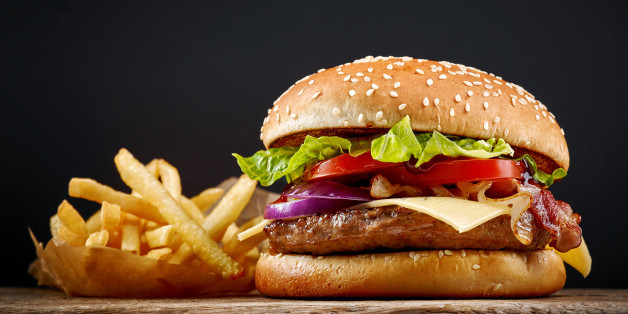 fresh tasty burger and french fries on wooden table