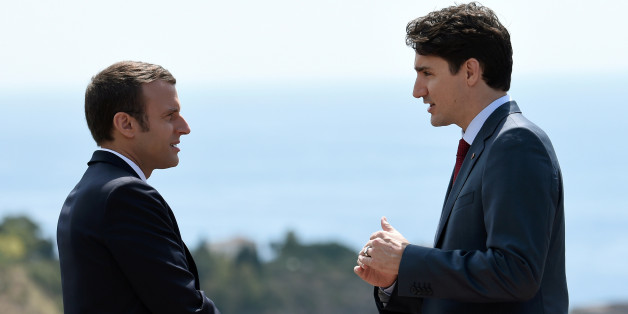 Canadian Prime Minister Justin Trudeau (R) and French President Emmanuel Macron talk as they attend the G7 Summit in Taormina, Sicily, Italy, May 26, 2017. REUTERS/Stephane De Sakutin/Pool
