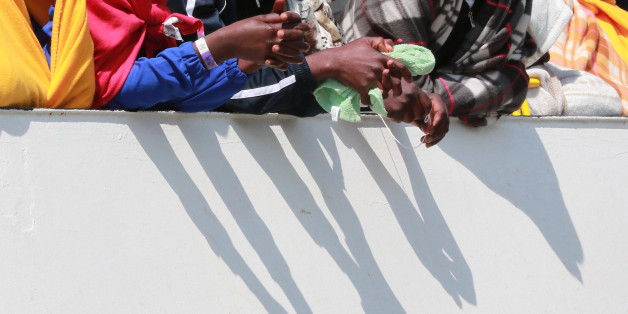 Migrants wait to disembark from the Aquarius rescue Ship run by NGO S.O.S. Mediterranee and Medecins Sans Frontieres in the port of Salerno after a rescue operation in the Mediterranean sea, on May 26 2017. 1004 migrants including 240 children disembark from the Aquarius today.
More than 50,000 migrants have landed on Italian coasts since the beginning of this year, not counting those rescued in recent days, while more than 1,400 have drowned or are missing, according to the UN. / AFP PHOTO / CARLO HERMANN (Photo credit should read CARLO HERMANN/AFP/Getty Images)