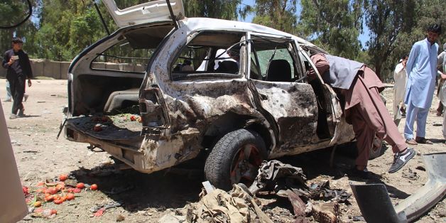 Afghan residents gather at the scene of a suicide car bomb that targeted a CIA-funded pro-government militia force at a public bus station in Khost province on May 27, 2017. A suicide car bomber killed 13 people in the eastern Afghan city of Khost on May 27, officials said, in the first major insurgent attack at the start of the holy fasting month of Ramadan. / AFP PHOTO / FARID ZAHIR (Photo credit should read FARID ZAHIR/AFP/Getty Images)