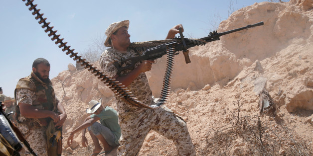 A fighter of Libyan forces allied with the U.N.-backed government fires a weapon during a battle with IS fighters in Sirte, Libya, July 21, 2016. REUTERS/Goran Tomasevic TPX IMAGES OF THE DAY