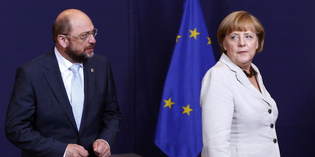 European Parliament President Martin Schulz (L) and Germany's Chancellor Angela Merkel (R) take part in a group photo during a EU summit in Brussels June 27, 2013. European officials struck two significant deals on banking resolution and their long-term budget in last-ditch negotiations early on Thursday, giving EU leaders a much needed lift before a summit on youth unemployment and growth. REUTERS/Yves Herman (BELGIUM - Tags: POLITICS BUSINESS EMPLOYMENT)