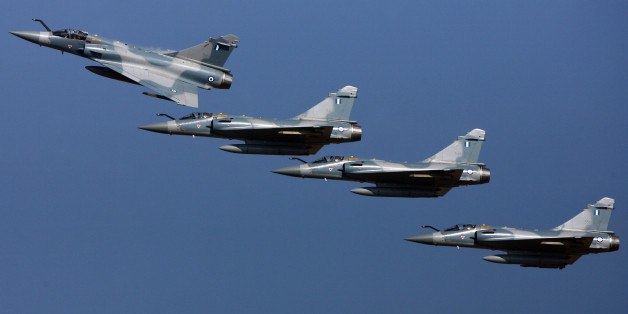 Four Mirage 2000-5 fly over the military airport of Tanagra, some 100 kilometers north of Athens, 23 November 2007. Greece incorporated 15 Mirage 2000-5 fighter jets into its airforce in a ceremony officiated over by Greek Defence Minister Evangelos Meimarakis and his French counterpart Herve Morin. The jets had been commissioned from French contractor Dassault in 2000 at a price of 1.6 billion euros. AFP PHOTO / Aris Messinis / AFP / ARIS MESSINIS (Photo credit should read ARIS MESSINIS/AFP/Getty Images)
