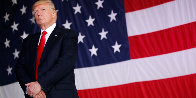 U.S. President Donald Trump stands in front of a U.S. flag while listening to U.S. first lady Melania Trump give a speech to U.S. troops at the Naval Air Station Sigonella before returning to Washington D.C. at Sigonella Air Force Base in Sigonella, Sicily, Italy, May 27, 2017REUTERS/Jonathan Ernst