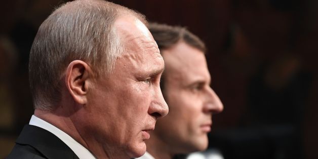 Russian President Vladimir Putin (front) delivers a speech during a joint press conference with French President Emmanuel Macron (rear) in the Galerie des Batailles (Gallery of Battles) following their meeting at the Versailles Palace, near Paris, on May 29, 2017.
French President Emmanuel Macron hosts Russian counterpart Vladimir Putin in their first meeting since he came to office with differences on Ukraine and Syria clearly visible. / AFP PHOTO / POOL / STEPHANE DE SAKUTIN (Photo credit should read STEPHANE DE SAKUTIN/AFP/Getty Images)