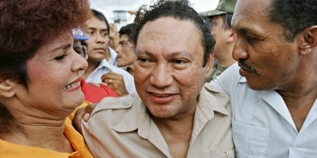 Panamian military strong man General Manuel Antonio Noriega smiles with supporters who embrace him 14 June 1987 upon his arrival in the small remote city of David, about 350 kilometers from the capital. Noriega made the visit to show he had popular support of the people and that sporadic demonstraions against his regime are isolated to the capital. (Photo credit should read JONATHAN UTZ/AFP/Getty Images)