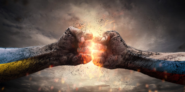 Close up of two fists hitting each other over dramatic sky