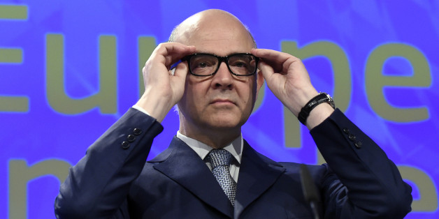 EU Commissioner of Economic and Financial Affairs, Taxation and Customs Pierre Moscovici puts his glasses on before delivering a speech during a joint press conference regarding European semester package on country specific recommendations, at the EU headquarters, in Brussels on May 22, 2017. / AFP PHOTO / JOHN THYS (Photo credit should read JOHN THYS/AFP/Getty Images)