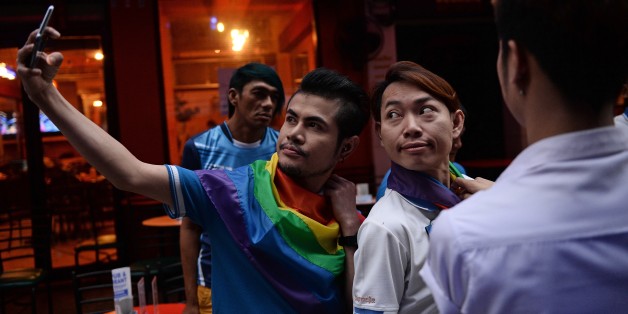 Members of the LGBT community in Thailand take photos as they gather in Bangkok on June 18, 2016 to take part in a vigil for victims of the worst mass shooting in modern US history in Orlando, Florida.Forty-nine people were killed and 53 wounded when a 29-year-old man ran amok in a packed gay nightclub early on June 12 in Orlando, armed with a legally bought assault rifle. / AFP / LILLIAN SUWANRUMPHA (Photo credit should read LILLIAN SUWANRUMPHA/AFP/Getty Images)