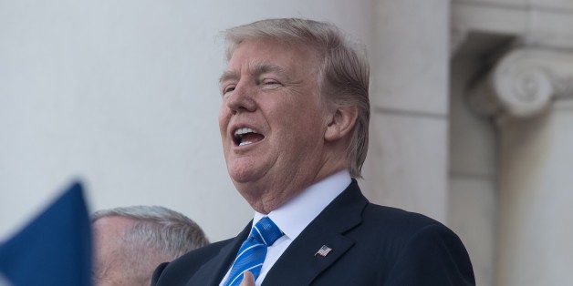 US President Donald Trump sings the national anthem before speaking at Arlington National Cemetery to mark Memorial Day in Arlington, Virginia, on May 29, 2017. / AFP PHOTO / NICHOLAS KAMM (Photo credit should read NICHOLAS KAMM/AFP/Getty Images)