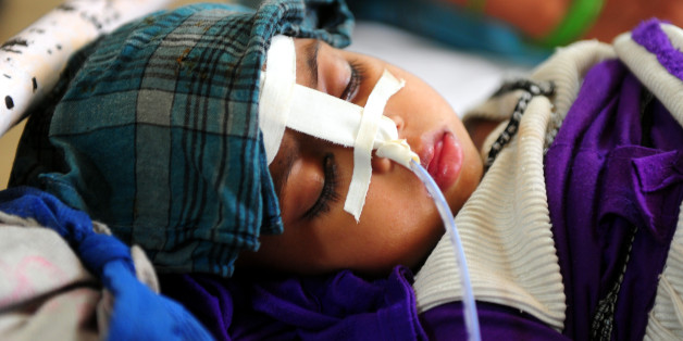 An eight month old Indian baby suffering from diarrhoea lies on a bed at a Government children's hospital in Allahabad on May 20, 2013. There has been in increase of children suffering from diarrhoea and other illnesses as temperatures reach 48 Celsius (118 Fahrenheit). AFP PHOTO/ SANJAY KANOJIA (Photo credit should read Sanjay Kanojia/AFP/Getty Images)