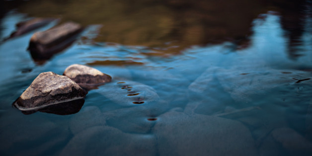 Rocks in stream with smooth flowing water