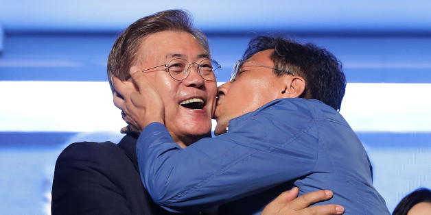 SEOUL, SOUTH KOREA - MAY 09: South Chungcheong governor An Hee-jung kisses South Korean President-elect Moon Jae-in, of the Democratic Party of Korea, at Gwanghwamun Square on May 9, 2017 in Seoul, South Korea. Moon Jae-in declared victory in South Korea's presidential election, which was called seven months early after former President Park Geun-hye was impeached for her involvement in a corruption scandal. (Photo by Chung Sung-Jun/Getty Images)
