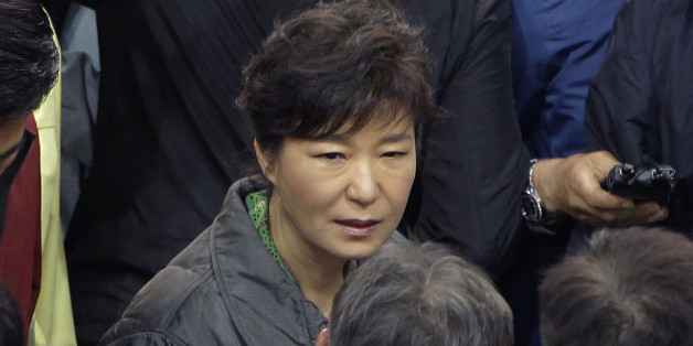 JINDO-GUN, SOUTH KOREA - APRIL 17: South Korean President Park Geun-Hye talks with relatives of missing passengers of a sunken ferry at Jindo gymnasium on April 17, 2014 in Jindo-gun, South Korea. Six are dead, and 290 are missing as reported. The ferry identified as the Sewol was carrying about 470 passengers, including the students and teachers, traveling to Jeju Island. (Photo by Chung Sung-Jun/Getty Images)