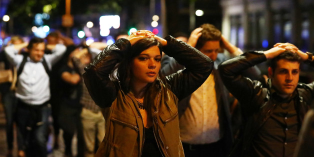 People leave the area with their hands up after an incident near London Bridge in London, Britain June 4, 2017. REUTERS/Neil Hall