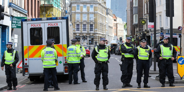 Police officers create a cordon line as they stand in the area near a terror attack in London, U.K., on Sunday, June 4, 2017. A van swerved into Saturday-night crowds on London Bridge, before three men got out and went on a stabbing rampage through nearby bars. Photographer: Luke MacGregor/Bloomberg via Getty Images