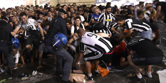 Football Soccer - Juventus v Real Madrid - UEFA Champions League Final - San Carlo Square, Turin, Italy - June 3, 2017 Juventus' fans run away from San Carlo Square following panic created by the explosion of firecrackers as they was watching the match on a giant screen. REUTERS/Giorgio Perottino