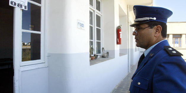 ALGIERS, ALGERIA: An Algerian policeman stands guard while a room of an Algiers casbah school is prepared for the elections 07 April 2004. On the eve of what is shaping up as the most democratic presidential election ever to be held in Algeria, the press and most of the candidates in the polls today accused the incumbent Abdelaziz Bouteflika of plotting to steal the vote. The tabloid press, quoting 'very reliable sources,' described a Machiavellian series of events in which state television wo