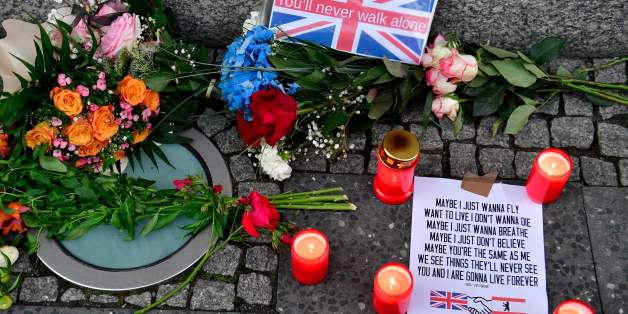 Flowers and candles as tribute to the victims of the June 3 terror attack in London are pictured on June 4, 2017 at the British embassy in Berlin. / AFP PHOTO / John MACDOUGALL (Photo credit should read JOHN MACDOUGALL/AFP/Getty Images)