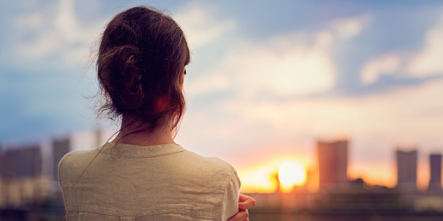 Young girl is watching sunset over Tokyo in Odaiba.