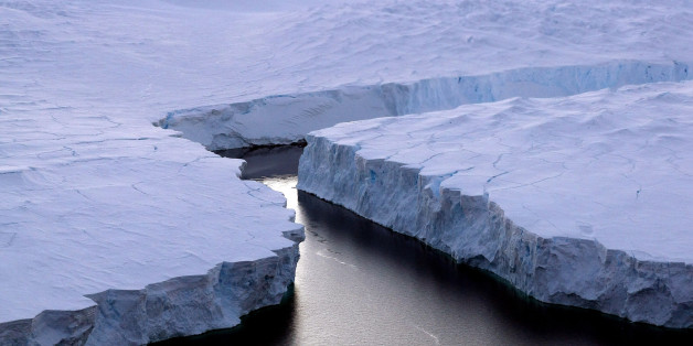 An enormous iceberg (R) breaks off the Knox Coast in the Australian Antarctic Territory on January 11, 2008. Australia's CSIRO's atmospheric research unit has found the world is warming faster than predicted by the United Nations' top climate change body, with harmful emissions exceeding worst-case estimates. AFP PHOTO/POOL/Torsten BLACKWOOD / AFP / TORSTEN BLACKWOOD (Photo credit should read TORSTEN BLACKWOOD/AFP/Getty Images)
