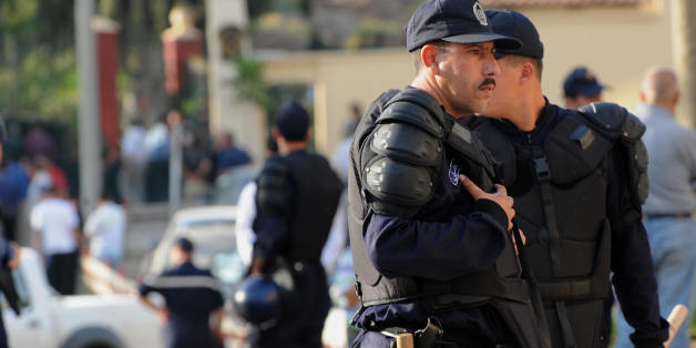 Algerian policemen secure the site of the blast carried by a suicide bomber in front of the gate of the republican guard's barracks in the eastern Algiers suburb of Bordj El Kiffan on June 4, 2008. The suicide bomber blew himself up near a police barracks on the outskirts of the Algerian capital, wounding several people, an AFP reporter and security officials said. AFP PHOTO/FAYEZ NURELDINE (Photo credit should read FAYEZ NURELDINE/AFP/Getty Images)