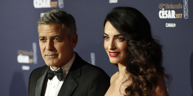 Actor George Clooney and his wife Amal pose as they arrive at the 42nd Cesar Awards ceremony in Paris, France, February 24, 2017. REUTERS/Gonzalo Fuentes