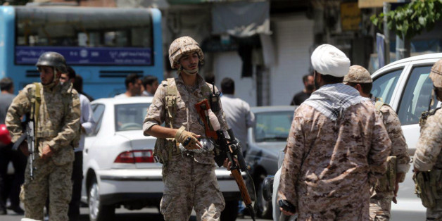 Members of the Iranian Revolutionary Guard secure the area outside the Iranian parliament during an attack on the complex in the capital Tehran on June 7, 2017.Gunmen and suicide bombers carried out coordinated attacks on Iran's parliament and the tomb of revolutionary founder Ruhollah Khomeini on June 7, 2017, state media reported, killing at least three people. / AFP PHOTO / FARS NEWS / Hossein MERSADI (Photo credit should read HOSSEIN MERSADI/AFP/Getty Images)