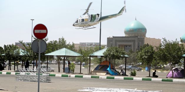 A picture taken on June 7, 2017, shows a police helicopter flying around outside the mausoleum of Ayatollah Ruhollah Khomeini in Tehran.
Gunmen and suicide bombers stormed Iran's parliament and the shrine of its revolutionary leader, killing 12 people in the first attacks in the country claimed by the Islamic State group. / AFP PHOTO / MIZA NEWS / Hasan SHIRVANI (Photo credit should read HASAN SHIRVANI/AFP/Getty Images)