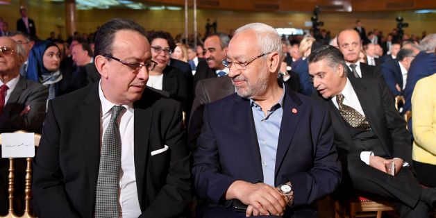 Hafedh Caid Essebsi (L), leader of Nidaa Tounes party, talks with Tunisian Islamist Ennahdha party leader Rached Ghannouchi, as they attend an official speech delivered by the Tunisian President Beji Caid Essebsi (unseen) on May 10, 2017 in Tunis.
Essebsi said that the army will protect the output of Tunisia's main resources from being disrupted by protests over social and labour issues. / AFP PHOTO / FETHI BELAID (Photo credit should read FETHI BELAID/AFP/Getty Images)