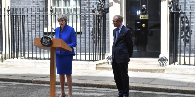 Britain's Prime Minister and leader of the Conservative Party Theresa May, (L), accompanied by her husband Philip, delivers a statement outside 10 Downing Street in central London on June 9, 2017 as results from a snap general election show the Conservatives have lost their majority.
British Prime Minister Theresa May will on Friday seek to form a new government, resisting pressure to resign after losing her parliamentary majority ahead of crucial Brexit talks. May is set to meet the head of state Queen Elizabeth II and ask for permission to form a new government, according to her Downing Street office. / AFP PHOTO / Ben STANSALL (Photo credit should read BEN STANSALL/AFP/Getty Images)
