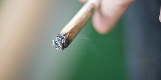 Man smoking marijuana cigarette soft drug in Amsterdam, Netherlands