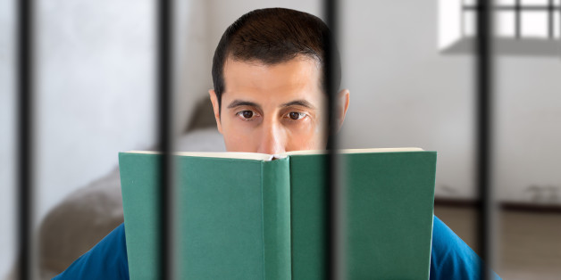 prisoner reading a book in his cell at the jail