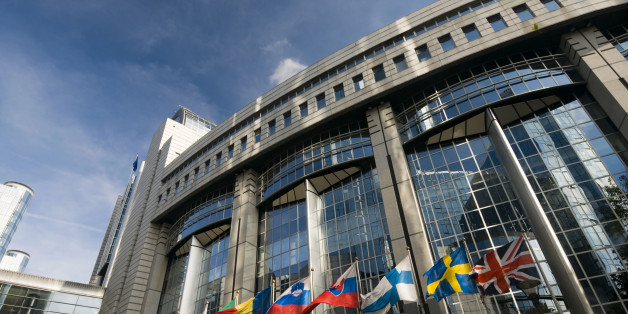 European Parliament in Brussels and a row of EU member states flags.